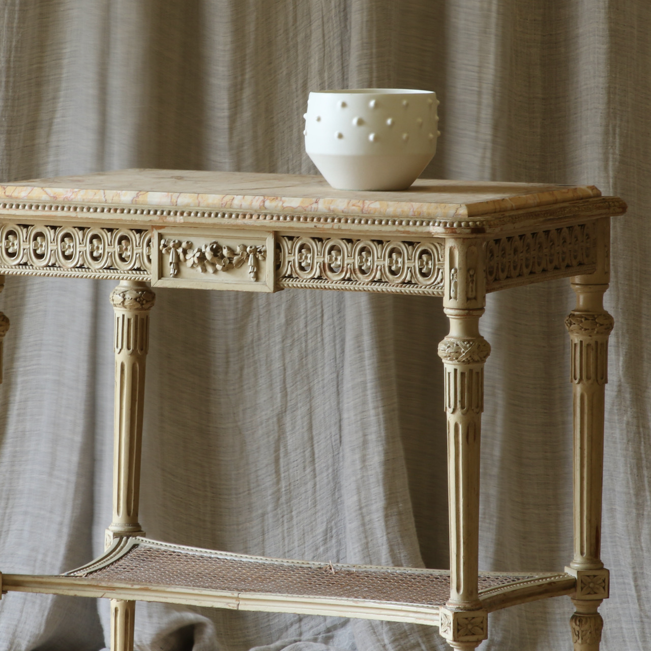 A Caned and Marble-Topped Table