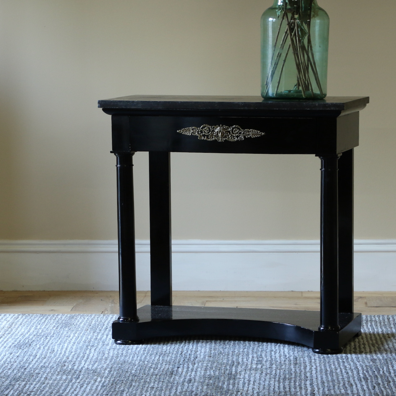 An Ebonised Empire Console